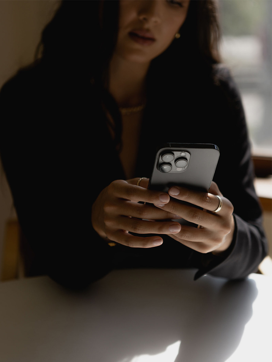 Beauty professional using her phone to research ways to upgrade your beauty website.